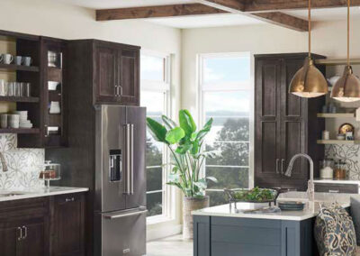 Kitchen with dark wood cabinets, blue island, quartz countertops, and exposed ceiling beams