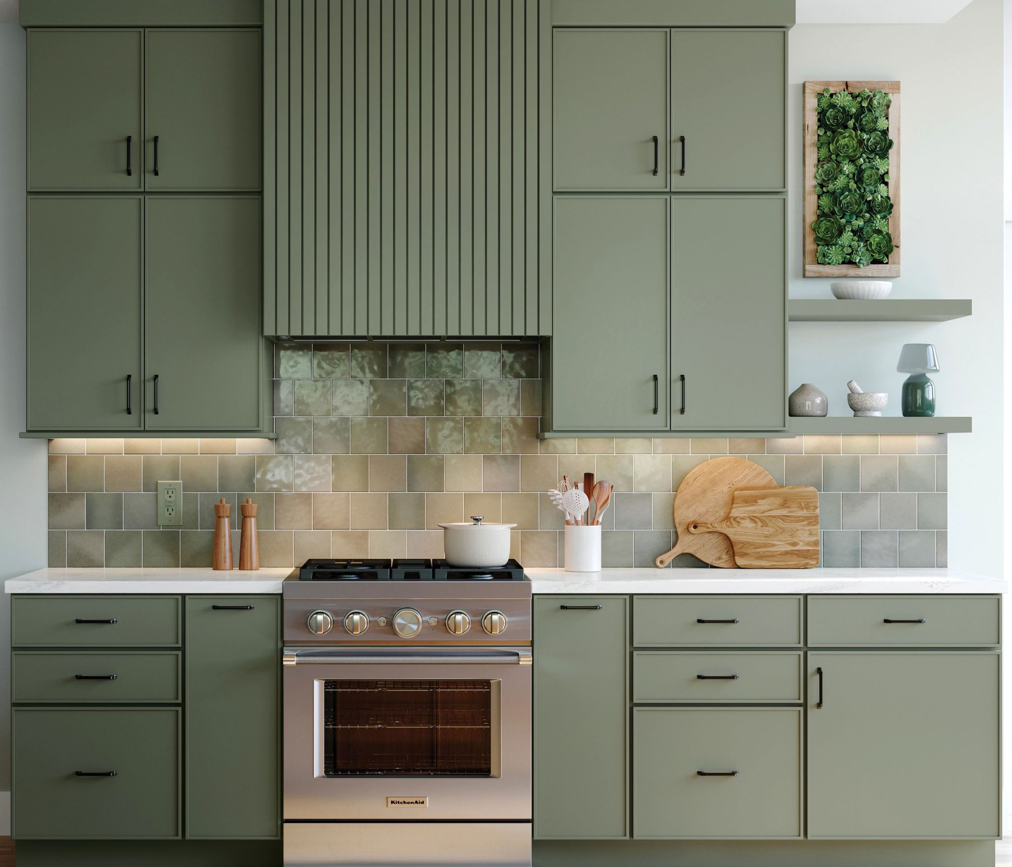 Sage green kitchen cabinets with slab and shaker fronts, quartz countertops, and a stainless gas range.