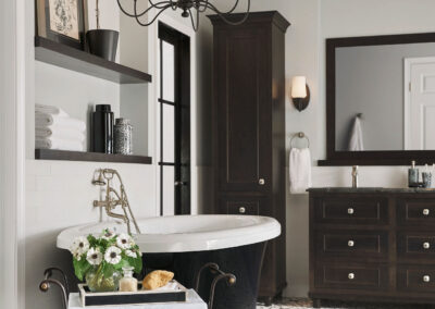 Floating wooden bathroom shelves above a white sink and counter, styled with towels and decorative items in a bright bathroom.
