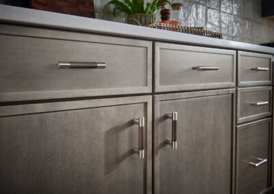 Kitchen with brown lower cabinets, white countertops, and a white tile backsplash.