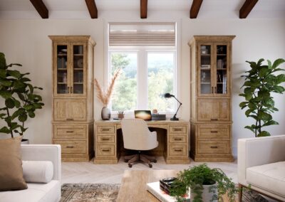 Bright home office with built-in white cabinets, wood desk, and large window.