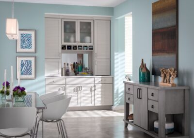 White built-in cabinet with glass-front upper doors and silver hardware.