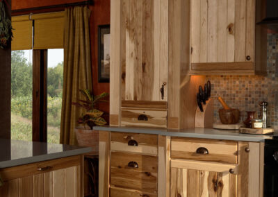 Modern kitchen with vertical wood panel cabinets, built-in appliances, and a matching island.